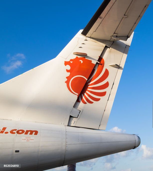 Bali, Indonesia - July 23, 2017: Tail section of Thai Lion Air airplane Parking at Ngurah Rai International Airport (Denpasar International Airport)